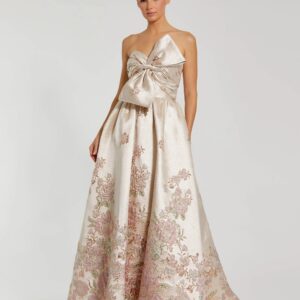 Strapless ball gown with brocade floral fabric and bow detail